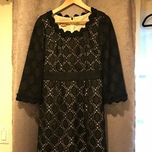 Elegant black dress with beige undertone.